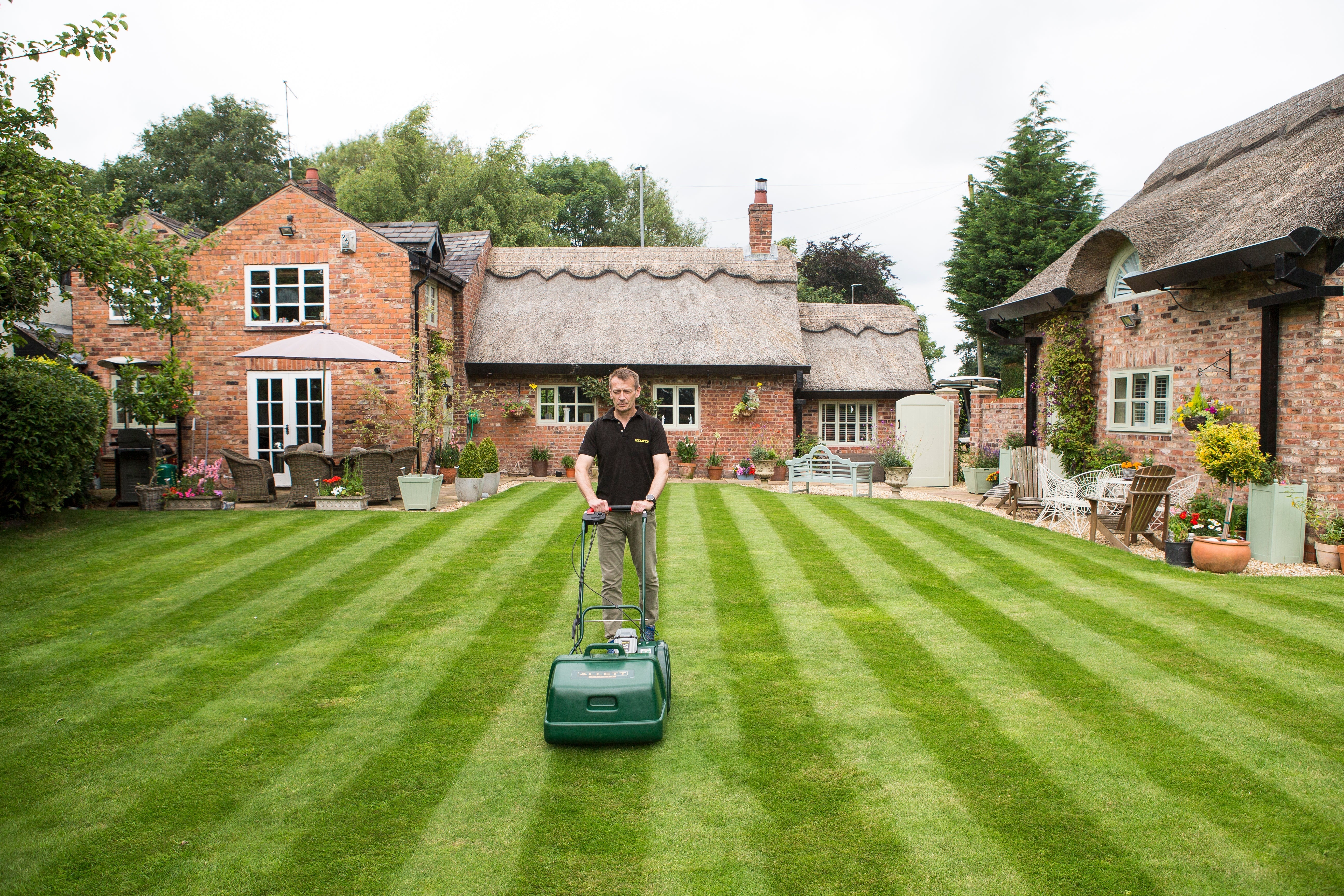 Man mowing with Liberty 43 demonstrating strong lawn stripes.