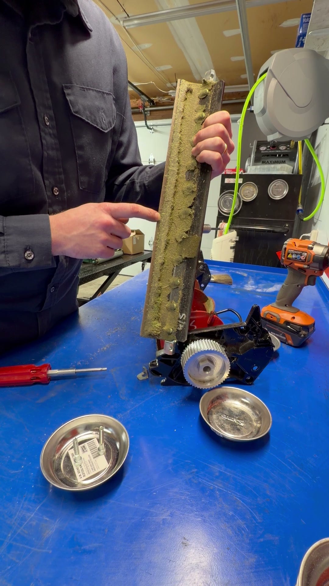 Worn Allett bottom blade held up for inspection — why regular reel grinding matters