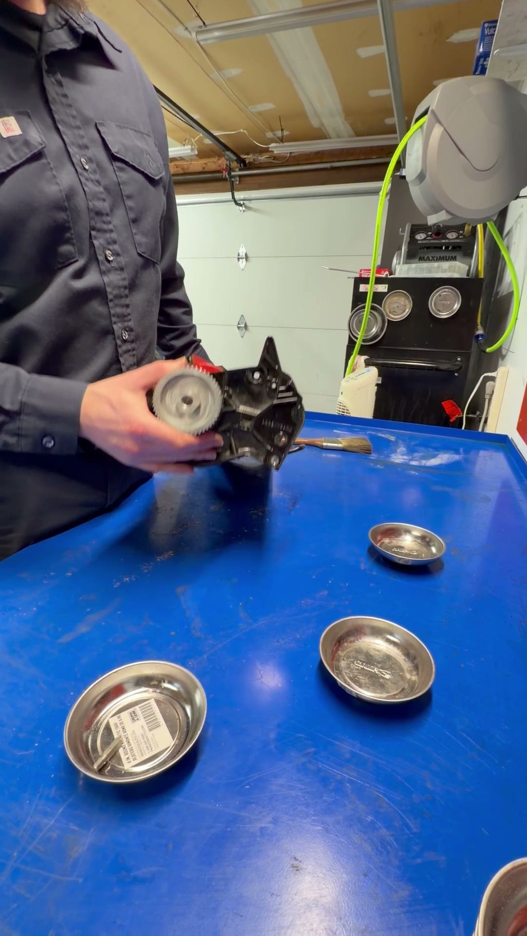 Technician holding an Allett reel cartridge — what you ship for mail-order reel grinding