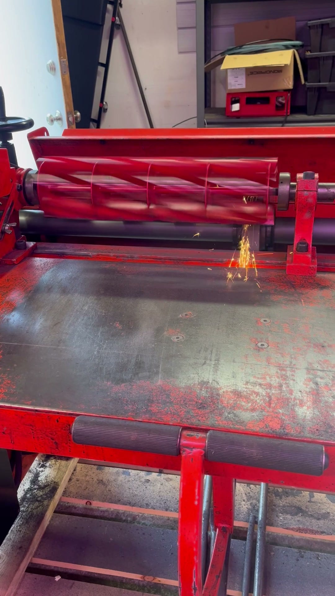 Homeowner Allett reel being precision-ground — sparks at the grinding wheel in the Ottawa workshop